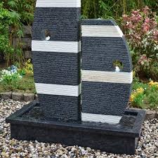 large outdoor stone boat shape water