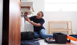female plumber working to fix leaking