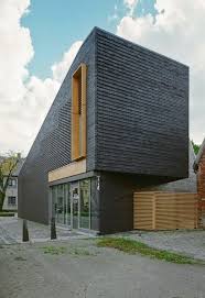 It was clear that no matter how carefully we tried to match the brick a homogenous finish would not be achieved, said the architects. Black Bricks Facade For Small House Design House Facade Design Ideas With Modern Front Design Of A House Ho Brick Facade Brick Architecture Facade Architecture