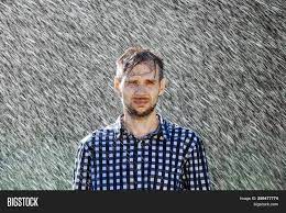 The rain doesn't get wet when it rains because the raindrops itself are water droplets. Man Wet Under Rain Image Photo Free Trial Bigstock