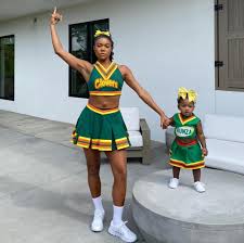 Then make some motifs and sew on, or get some transfer paper, print out a design, then iron onto the outfit. Gabrielle Union And Kaavia Dress As Bring It On Cheerleaders Popsugar Family