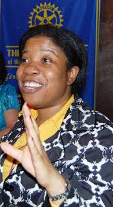 Ellen Haggerty, Chair of the Rotarians for Hearing Action Group and a  member of the Pleasant Valley New York Rotary Club exchanges club banners  and presents President Bob Fuhrman with a check