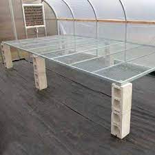 The style of this potting table is simple, yet it looks great in the garden. Ez Grow Continuous Greenhouse Benches Farmtek Greenhouse Benches Diy Greenhouse Shelves Greenhouse Tables
