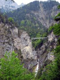 A city full of history with a baroque abbey, the basilica, various museums, old city walls and the remarkable castle 'hohe schloss'.enjoy the special atmosphere in the old city full of fountains, cafes and shops. Bridge Over Waterfall Next To Neuschwanstein Castle Bavaria Germany Neuschwanstein Castle Favorite Places Railway Bridges