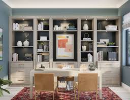 The ceiling is very high and the shelves take advantage of this, adding because the ceiling is also sloped, the shelves are staggered to follow the angle. Custom Home Office Built Ins Cabinet Storage California Closets