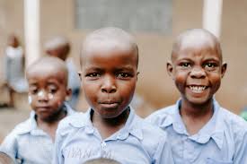 Boy blowing green balloon photo