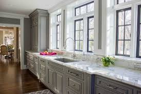 Example of windows behind cabinets with glass doors. Gray Kitchen Cabinets With Marble Window Sills Contemporary Kitchen