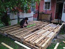 Build this easy, inexpensive pallet wood deck. Outdoor Deck Made Out Of Pallets 1001 Pallets Pallet Deck Diy Pallet Decking Pallet Patio Decks