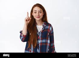 Excited thoughtful ginger girl, smile and pointing finger, got an idea,  have solution, pitching great plan, suggesting something, standing over  white Stock Photo - Alamy