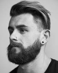Nathan McCallum with a full beard, nose piercing, and undercut style.