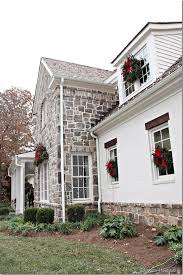 Other exterior highlights included trusses over the garage doors, horizontal lap siding and brick and stone accents. Home For The Holidays Showhouse Part 2 Modern Farmhouse Exterior Exterior Brick Stone Houses Exterior