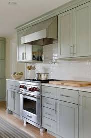Soothing Green Kitchen Features Sage Green Cabinets Paired With White Quartz Countertops And A W Kitchen Cabinet Design New Kitchen Cabinets Sage Green Kitchen