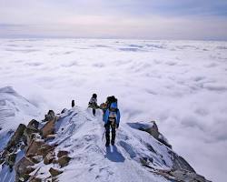 Image of person climbing a mountain to reach the peak