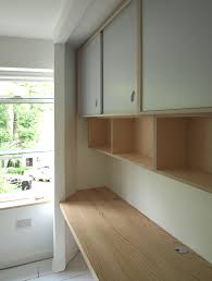 Wall Mounted Floating Birch Plywood Shelves And Cupboards With Painted Sliding Doors Desk In English As Plywood Shelves Plywood Kitchen Plywood Wall Paneling