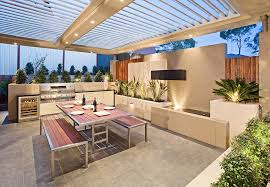 Off the outdoor living space is a complete kitchen and bar area with a dining spot, perfect for entertaining. 30 Fresh And Modern Outdoor Kitchens