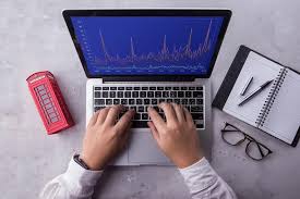 top of businessman using laptop computer with stock chart