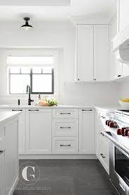 A white kitchen cupboard mix black hardware looks simple & modern. Gray Tiles Cover The Floors Of This Beautiful Black And White Kitchen Fitted With White Shaker Ca Kitchen Remodel Small New Kitchen Cabinets Kitchen Renovation