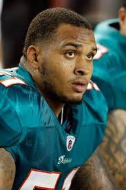 Dolphins center Mike Pouncey posts a message to his friend Aaron Hernandez