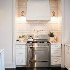 Subway tiles are beloved for their timelessness, so keep things classic with a white repeating bond pattern. American Olean White Subway Tile Design Ideas