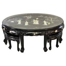 The top is round, made of sturdy wood, and covered in a cherry finish. Asian Style Black Lacquered Coffee Table With 4 Stools For Sale At 1stdibs