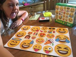 A cartoon image of a puzzle piece that is greenish in color. 100 Piece Eurographics Emoji Puzzle Minutes Of Fun Jigsawpuzzles