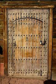 Old World Rustic Wooden Door With Bolts And Padlock Rustic Doors Old Wooden Doors Wooden Doors