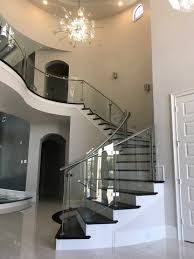 Modern curved staircase with glass railing. Curved Glass Houston Stair Company Inc