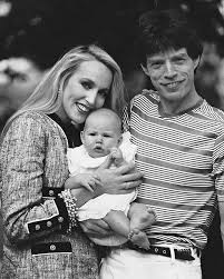 In this 1984 family photo, Mick Jagger, iconic frontman of "The Rolling Stones," poses alongside his then-partner Jerry Hall, a supermodel with undeniable style, and their young daughter Elizabeth, who would grow