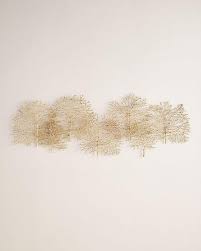The piece looks great hanging in multiples. Gold Metal Branches Overlapping Wall Art