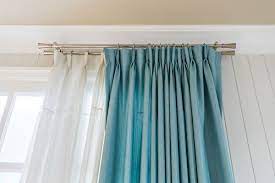 The fabric of this valance curtain hangs across brackets and drapes over the top of a window, with tails hanging down on each side. Are Drapes Outdated And Out Of Style Atlanta Discount Blinds
