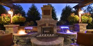 It features a column that pours the water out the sides into a lower basin that is raised off the ground around the column. Fire And Water Features By Elemental Landscapes Ltd