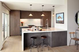 The dark grey cabinets contrast with the white countertops with a lot of decor drama taking place. A Pied A Terre Redesigned By A Master Of Mansions Wsj