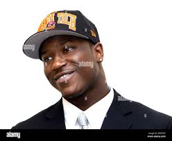 Joel Caleb, Clover Hill High School football standout, laughs with family  members while signing a contract to attend and play football at Virginia  Tech during National Signing Day