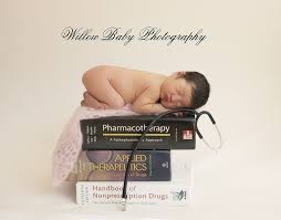 Newborn Photography Baby Doctor Picture With Baby On Stack Of Medical Books Newborn Photos Session Medical Photography Baby Photography Newborn Photography