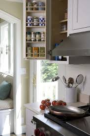 Stunning Kitchen With White Cabinets With Polished Nickel Hardware Cream Countertops And A White Kitchen Cabinet Storage Cottage Kitchen Kitchen Inspirations