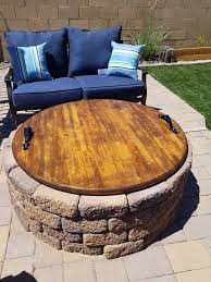 The circular design of the table accommodates more people than a rectangular one. A Unique Way To Cover An Outdoor Fire Pit When Not In Use Just A Table Top Some Metal Handles And Stain Love Fire Pit Table Patio Decor Fire Pit