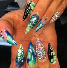 cassie exclusive spa on instagram notpolish stilettonails nailsonpoint blues glitternails bling swaro green nail designs rhinestone nails glam nails