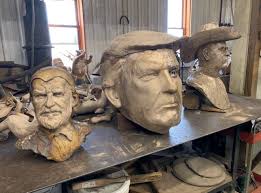 Crypto investors with the project $PATRIOT commissioned Ohio artist Alan  Cottrill to create a bronze statue of Trump when he threw his fist in the  air after the first attempt