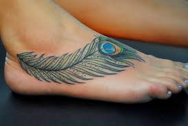 This feather tattoo on arm looking very awesome. 20 Peacock Feather Tattoos And The Beautiful Meanings Behind Them Tattooswin