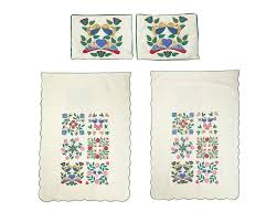 A pair of hand-stitched Amish or Mennonite quilts, by Mary Koons sold at  auction