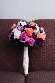 To start, select your flowers. Purple And Light Orange Wedding Flower Bridal Bouquet Wrapped With Champagne Satin Material From Wedding Flowers Bridal Bouquets Wedding Flowers Bridal Bouquet