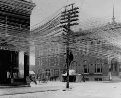 View of a lineman working on power Telephone lines at an intersection in  Pratt, Kansas, USA, 1911. [1858x1501] : rHistoryPorn