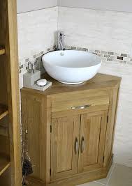 If you have room for a vanity and/or countertop, then your best bet is to install two small vessel sinks, each with their own faucet, on the right and left side of the counter. Oak And Ceramic Corner Bathroom Vanity Sink Set Click Bathroom Small Bathroom Sinks Corner Sink Bathroom Small Bathroom Vanities