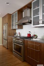 Walnut Cabinetry With Quartz Countertop Ge Range Frosted Glass Doors With Stainle Kitchen Cabinetry Design Kitchen Cabinet Interior Aluminum Kitchen Cabinets