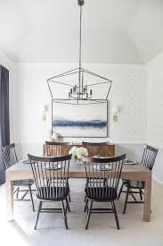 Tall Black Spindle Chairs Surround A Chunky Brown Oak Dining Table Placed Beneath A Large Black La Brown Dining Room White Wainscoting Round Back Dining Chairs