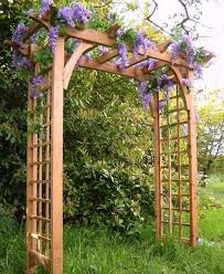 This modern take on the typical trellis (by yours truly!) is a great way to fill up a blank fence wall. 15 Beautiful Wooden Arches Creating Romantic Garden Design Garden Archway Garden Arches Garden Arbor Ideas