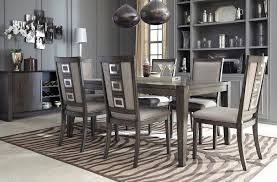 A pair of gray canvas and a tulip wall decor are mounted on the gray wall. Chadoni Dining Room Set Grey Dining Room Dining Table Modern Dining Room