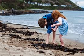 See boy dirty feet stock video clips. Boy And Girl On The Beach Looking At Dirty Feet Stock Photo Offset