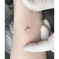 Black initials word tattoo on wrist. Initials Tattoo On The Wrist