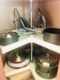Organize pots and pans in cabinet as previously mentioned you can use lid organizers inside the doors or installed inside the cabinet walls to keep your lids organized. 15 Space Saving Ways To Organize Pots Pans And Lids In The Kitchen